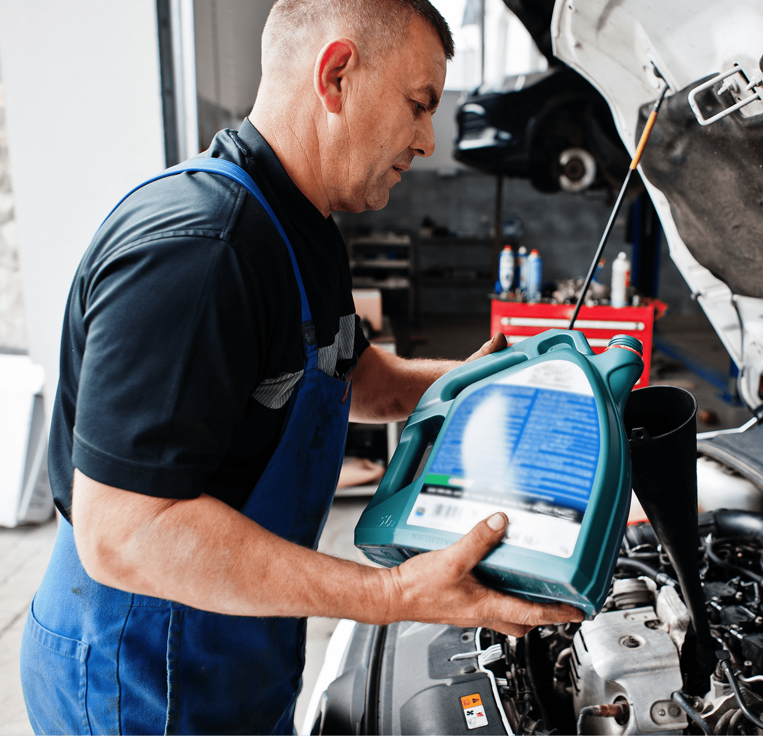 car-repair-maintenance-theme-mechanic-uniform-working-auto-service-pouring-new-motor-oil 1